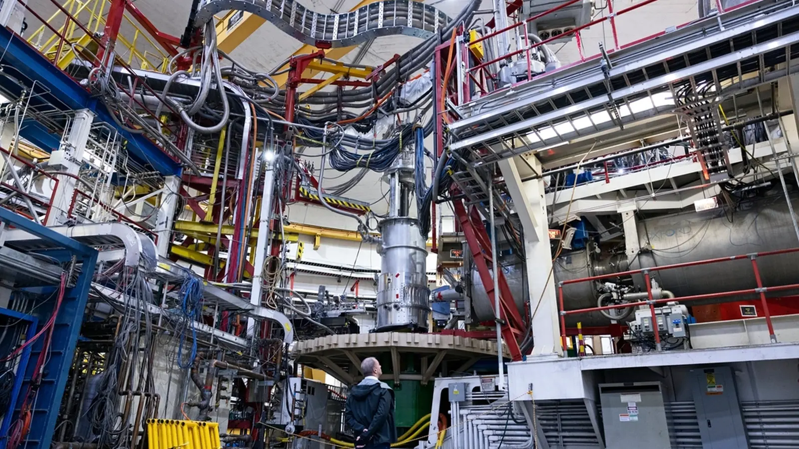 Industrial plant interior with pipes, machinery and walkways