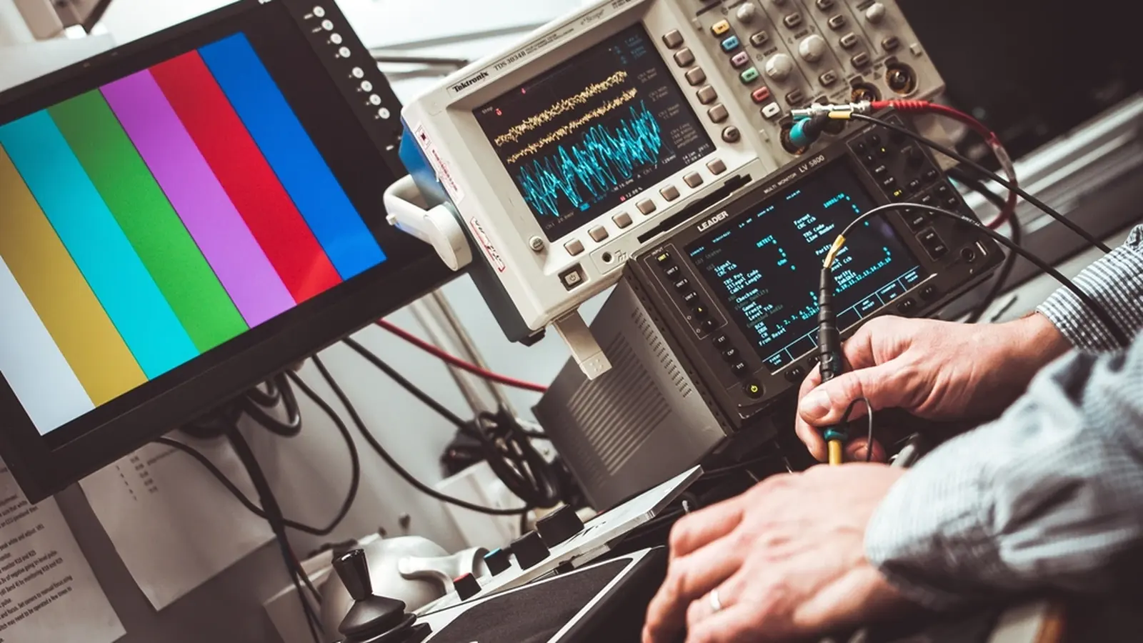 Engineer working with oscilloscopes and test equipment