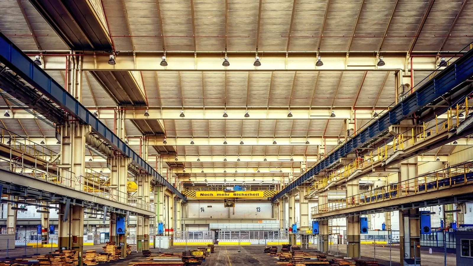 Large bright factory hall with overhead cranes
