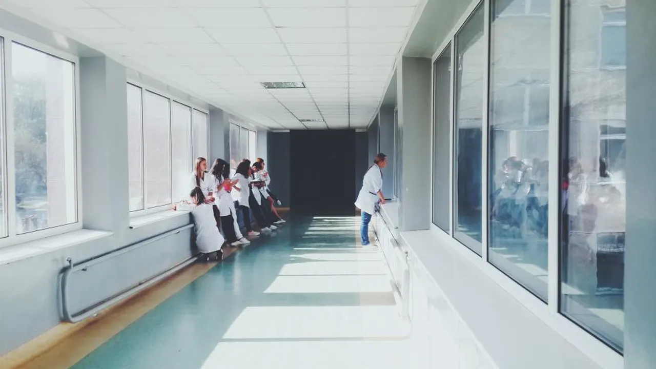 Bright hospital corridor with clinical staff