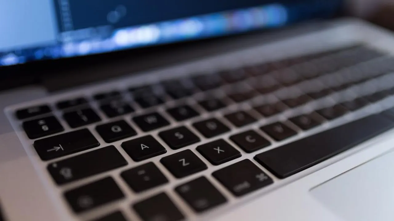 Laptop keyboard with code on screen
