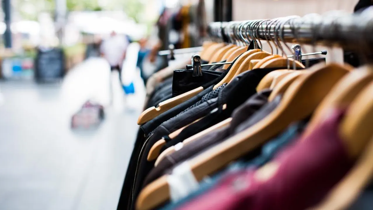 Clothes on hangers on a shop rail