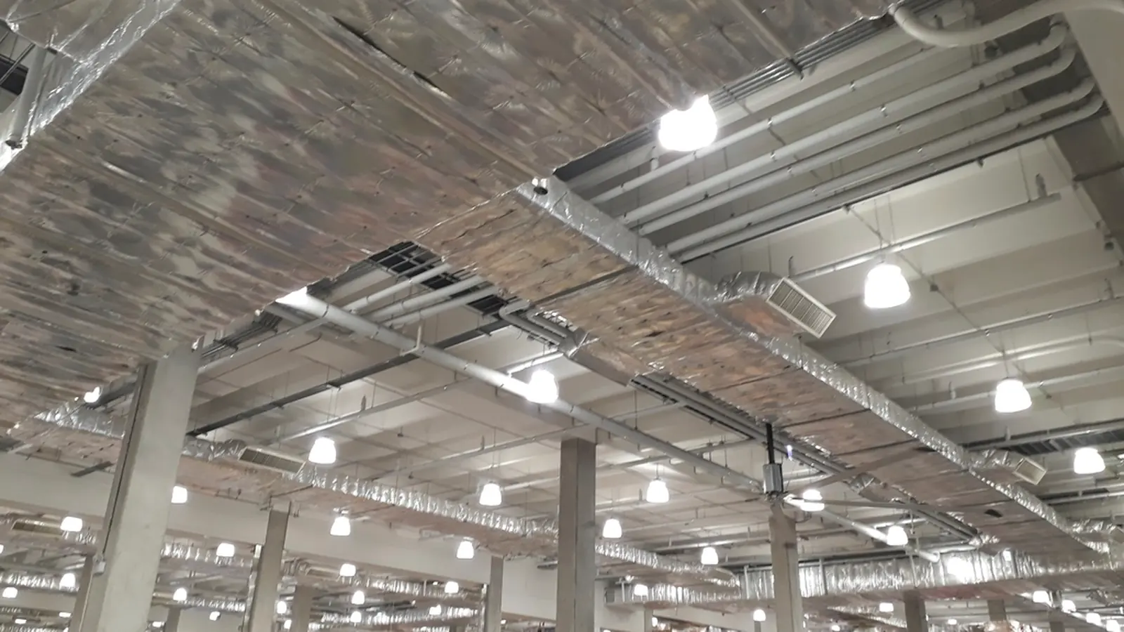 Modern empty warehouse with high racking and bright lights